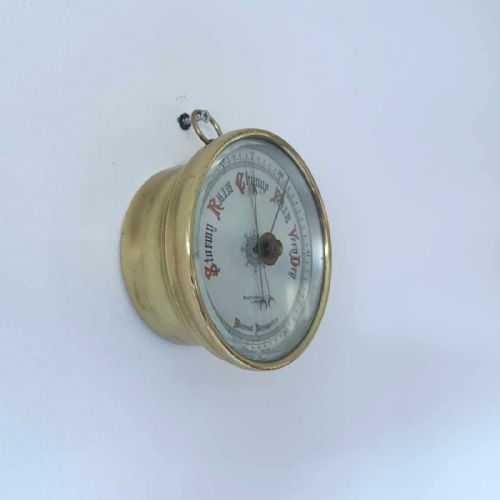 fig 2. A circular brass wall-hanging aneroid barometer featuring a silvered dial with Gothic lettering, calibrated scale, and multiple indicator pointers.