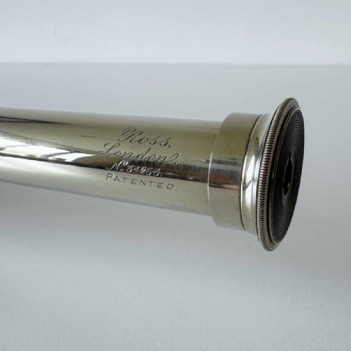 fig 4. A Victorian brass single draw marine telescope with a brown hexagonal barrel mounted on a dark wooden display stand.