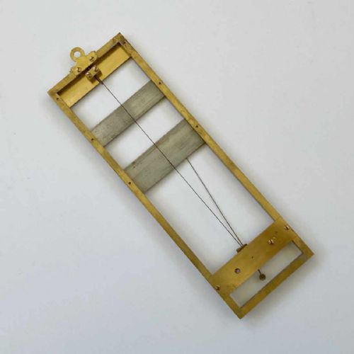 fig 2. A rectangular brass-framed Saussure hair hygrometer featuring engraved text plates and a curved graduated scale with a pointer needle.