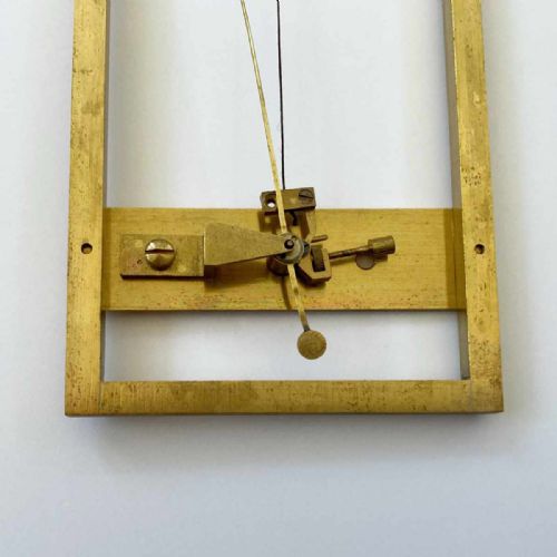 fig 6. A rectangular brass-framed Saussure hair hygrometer featuring engraved text plates and a curved graduated scale with a pointer needle.