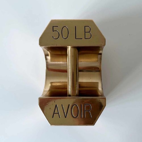 fig 3. A set of four graduated Edwardian brass avoirdupois standard weights displaying engraved weight values ranging from five to fifty pounds.