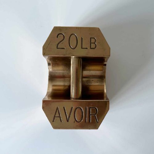 fig 6. A set of four graduated Edwardian brass avoirdupois standard weights displaying engraved weight values ranging from five to fifty pounds.