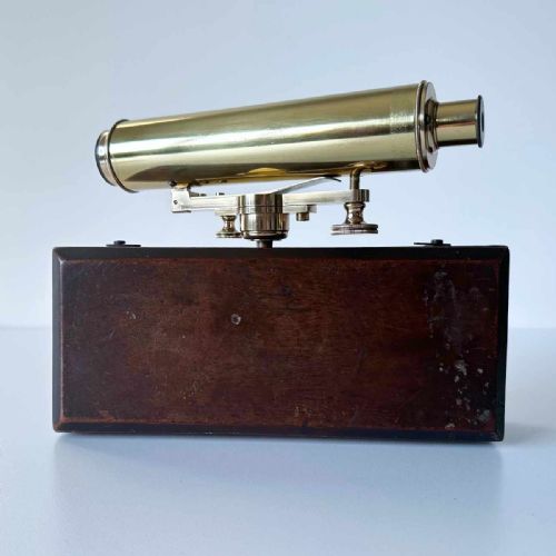 fig 5. An antique brass optical surveying drainage level positioned inside a open fitted mahogany wooden box.