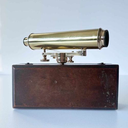 fig 6. An antique brass optical surveying drainage level positioned inside a open fitted mahogany wooden box.
