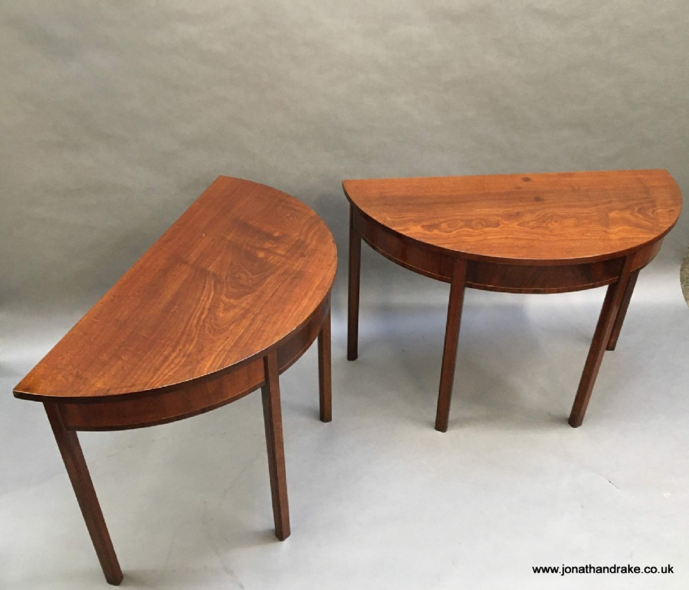A pair of George 111 demi-lune console tables