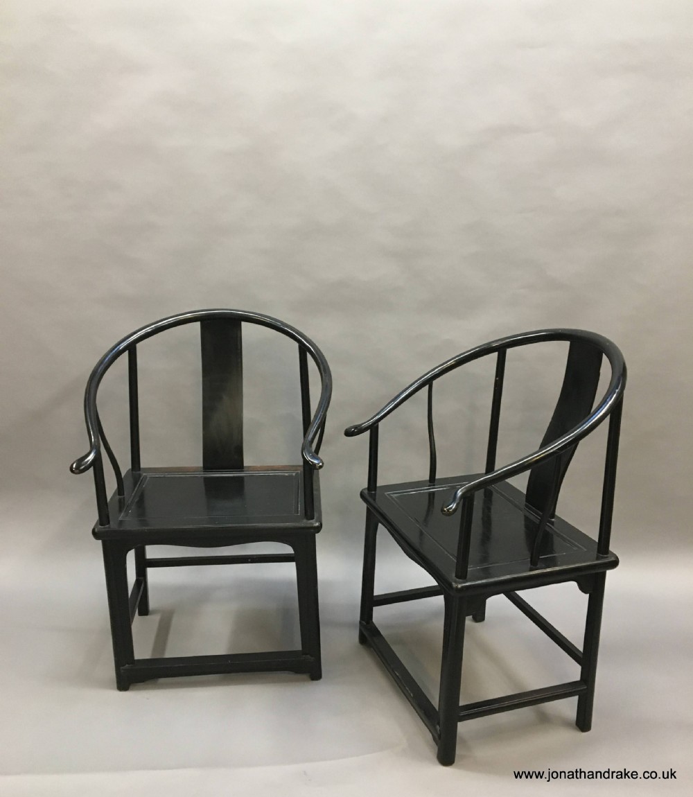 Pair Chinese ebonised horseshoe chairs