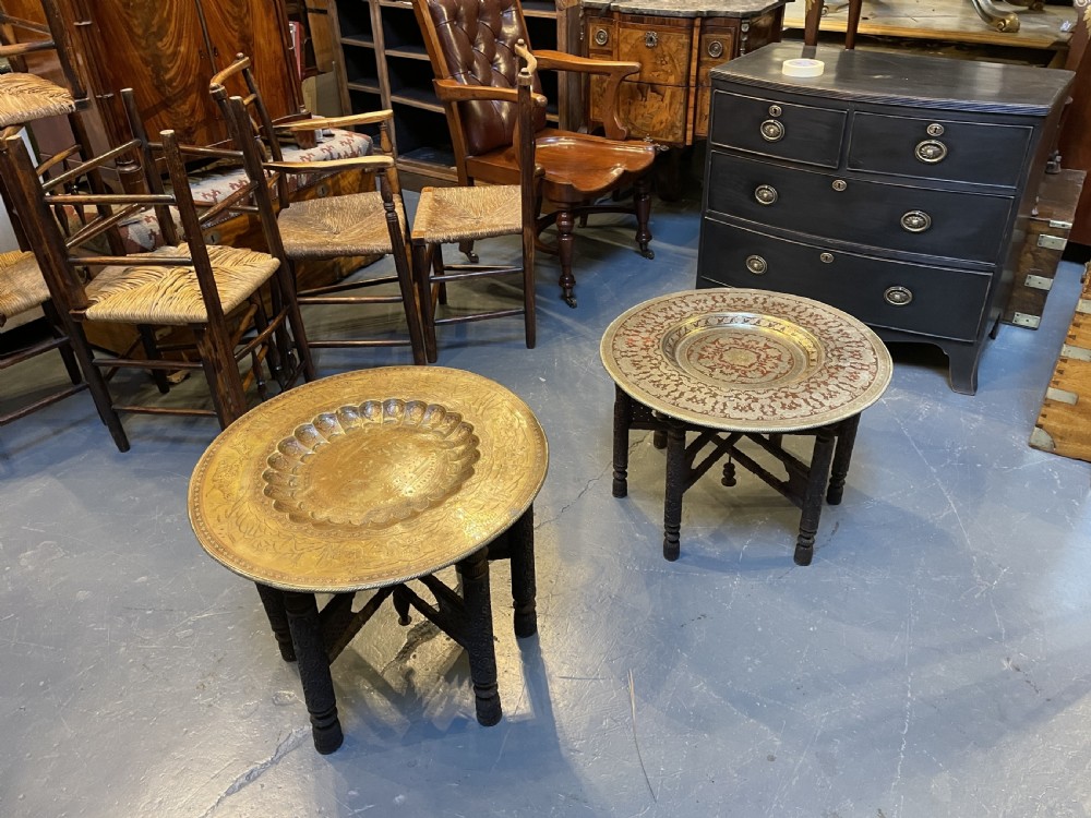 A low circular occasional table featuring an intricately etched multi-metal tray top resting on a dark carved wooden base. View XIV