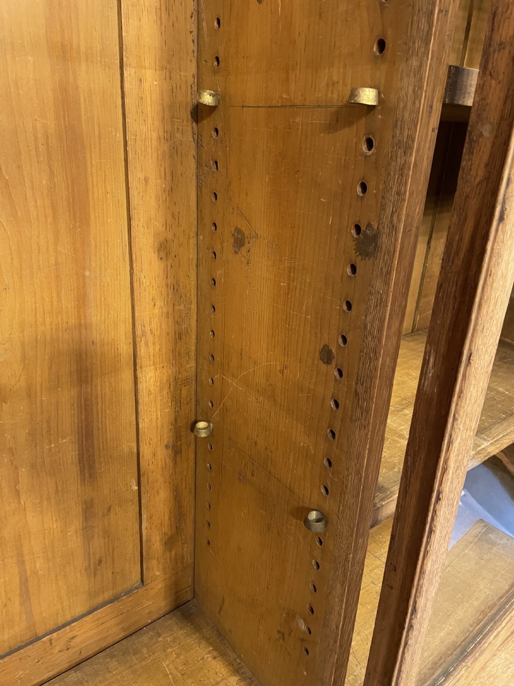A tall Victorian light oak two-part bookcase with two upper glazed doors revealing adjustable shelves and a two-door cupboard base. View V