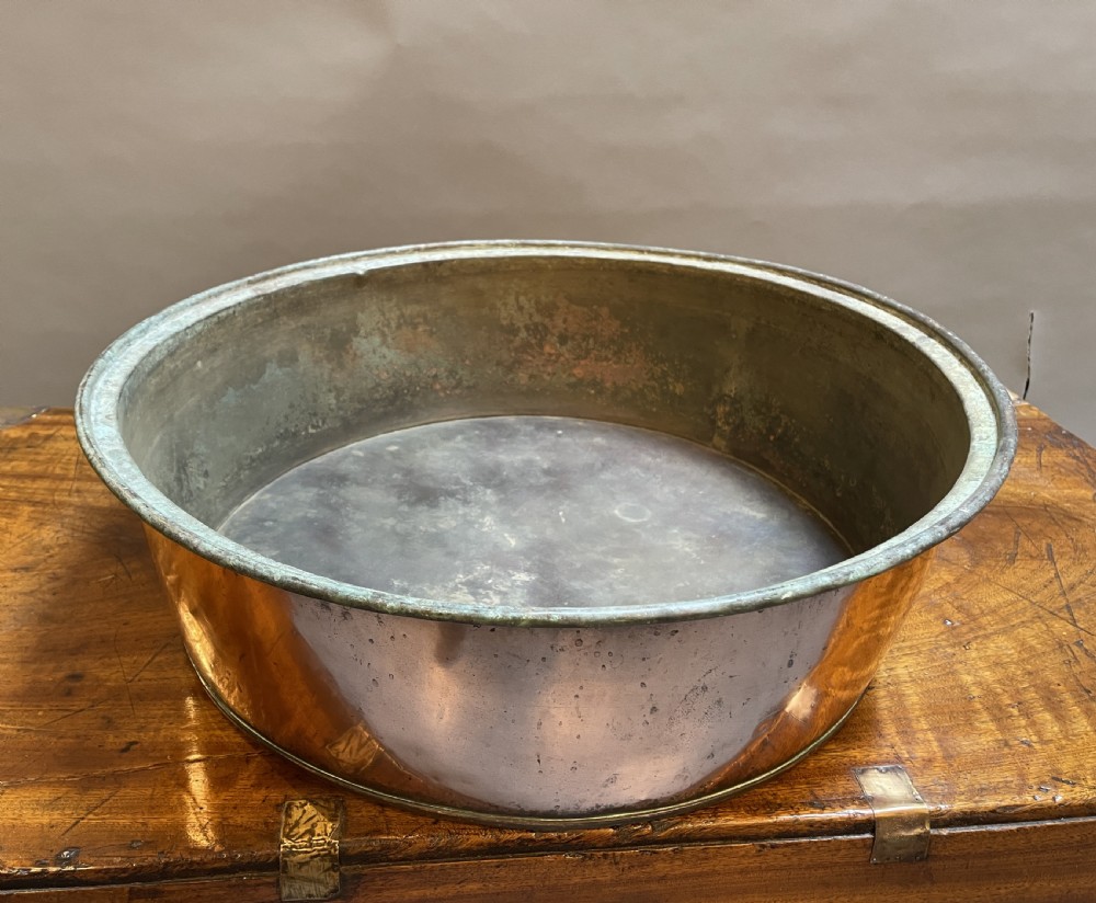 A large nineteenth-century circular copper preserve pan featuring flared sides, a rolled rim, and an aged interior showing signs of historical wear. View II