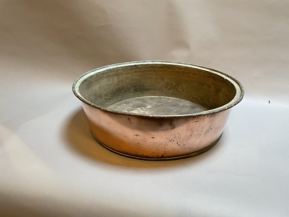 A large nineteenth-century circular copper preserve pan featuring flared sides, a rolled rim, and an aged interior showing signs of historical wear. View III