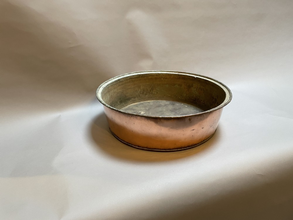 A large nineteenth-century circular copper preserve pan featuring flared sides, a rolled rim, and an aged interior showing signs of historical wear. View VI