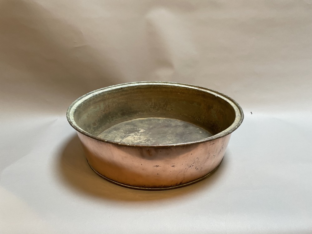 A large nineteenth-century circular copper preserve pan featuring flared sides, a rolled rim, and an aged interior showing signs of historical wear. View VII