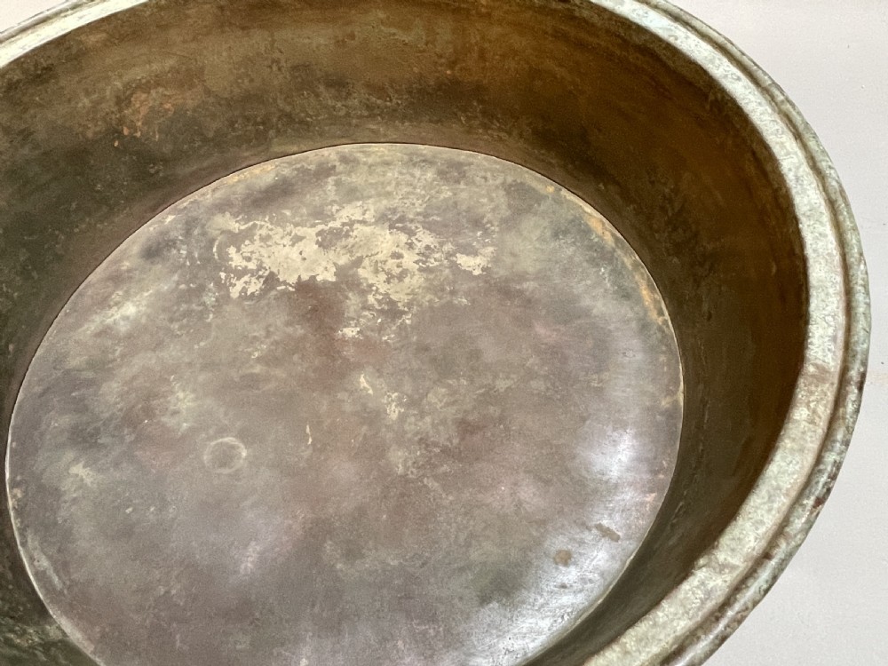 A large nineteenth-century circular copper preserve pan featuring flared sides, a rolled rim, and an aged interior showing signs of historical wear. View XI