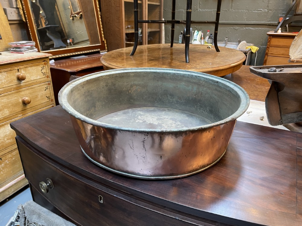 A large nineteenth-century circular copper preserve pan featuring flared sides, a rolled rim, and an aged interior showing signs of historical wear. View XII
