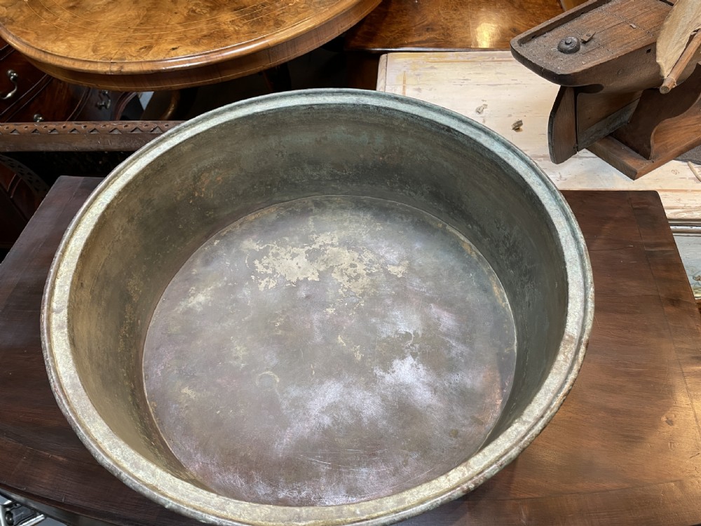 A large nineteenth-century circular copper preserve pan featuring flared sides, a rolled rim, and an aged interior showing signs of historical wear. View XIII