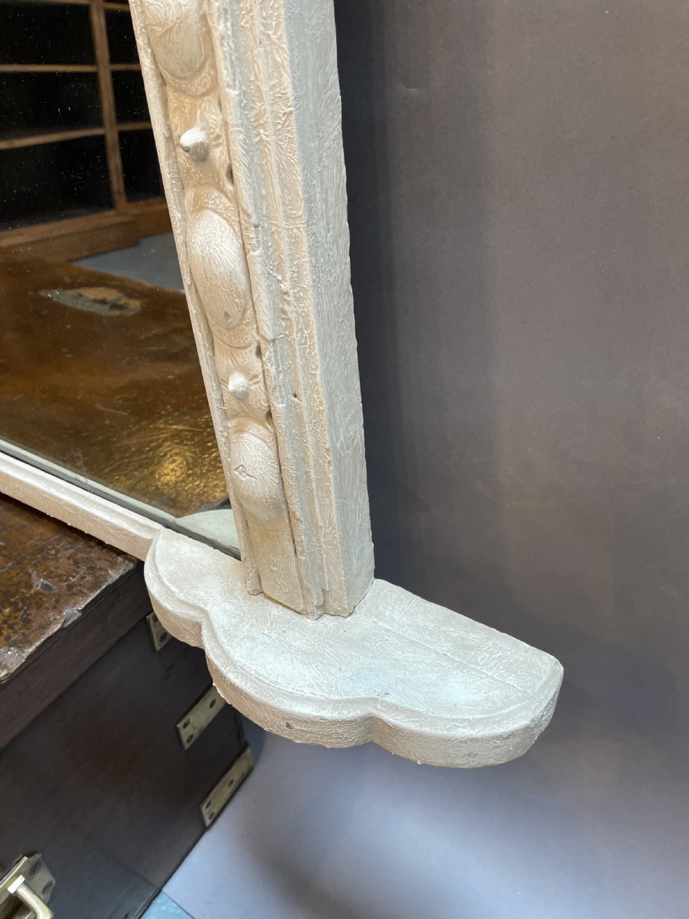 A 19th-century arched overmantel mirror featuring an off-white painted frame decorated with beaded moulding and small projecting feet. View IV