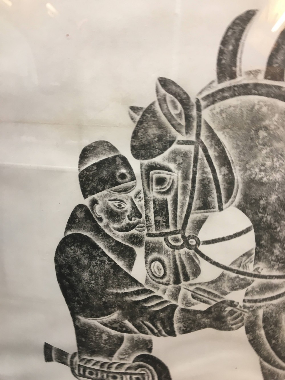 A large monochrome framed paper rubbing depicting a groom attending to a saddled Tang Dynasty horse. View X