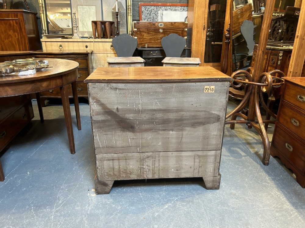A 19th-century mahogany chest of drawers featuring a serpentine front, four graduated drawers with ornamental brass handles, and bracket feet. View X