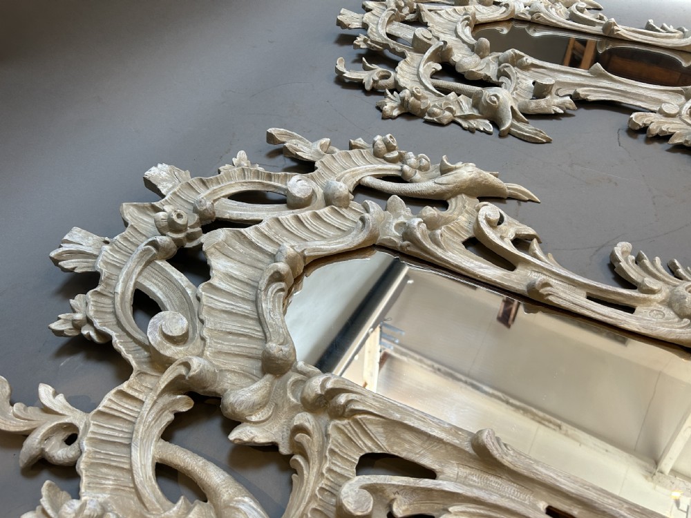 A 19th-century Continental wall mirror with an ornate carved off-white frame featuring intricate scrollwork, acanthus leaves, and shell motifs. View V