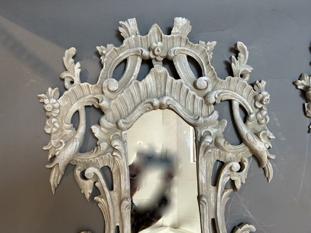 A 19th-century Continental wall mirror with an ornate carved off-white frame featuring intricate scrollwork, acanthus leaves, and shell motifs. View VII
