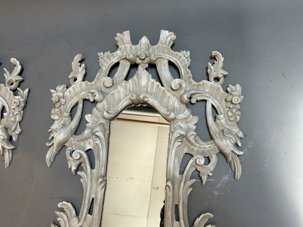 A 19th-century Continental wall mirror with an ornate carved off-white frame featuring intricate scrollwork, acanthus leaves, and shell motifs. View X