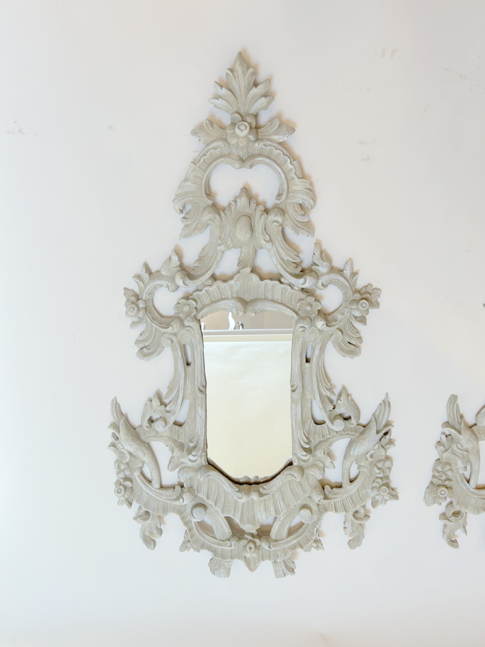 A 19th-century Continental wall mirror with an ornate carved off-white frame featuring intricate scrollwork, acanthus leaves, and shell motifs. View XI