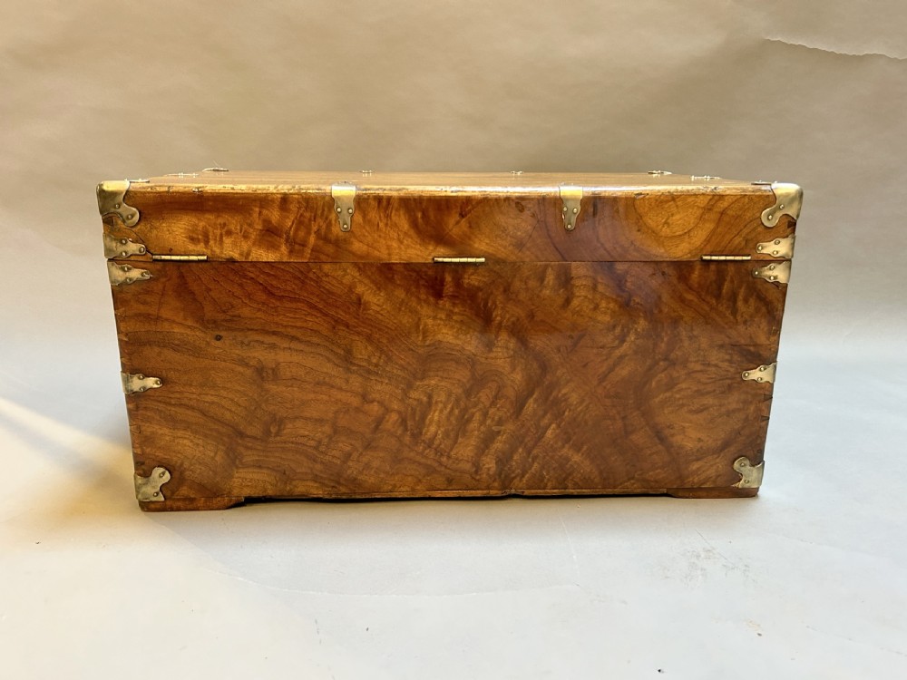 A rectangular solid camphor wood steamer trunk featuring metal corner brackets, metal latches, and side carrying handles. View IV