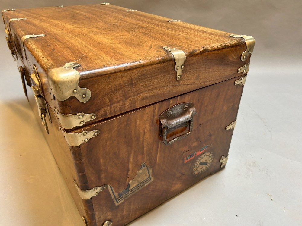 A rectangular solid camphor wood steamer trunk featuring metal corner brackets, metal latches, and side carrying handles. View VI