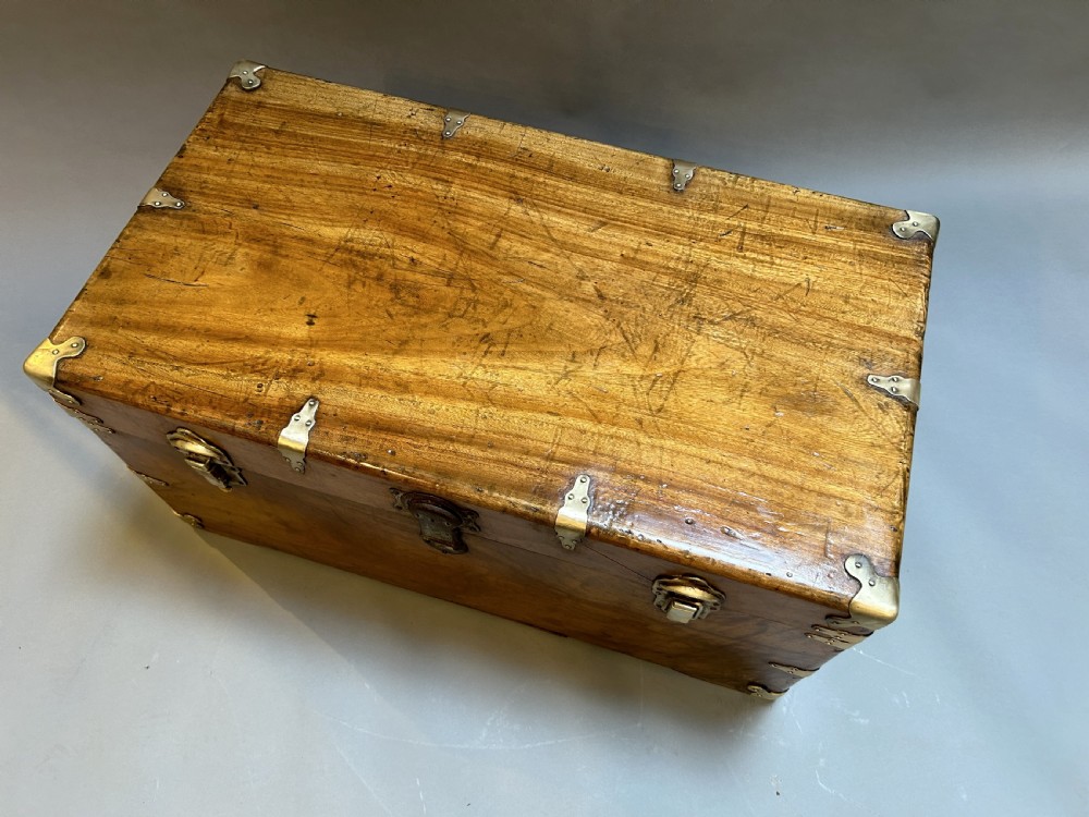 A rectangular solid camphor wood steamer trunk featuring metal corner brackets, metal latches, and side carrying handles. View VII