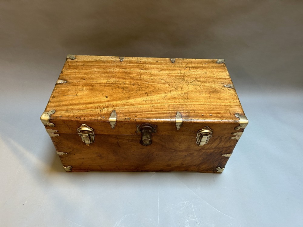 A rectangular solid camphor wood steamer trunk featuring metal corner brackets, metal latches, and side carrying handles. View IX