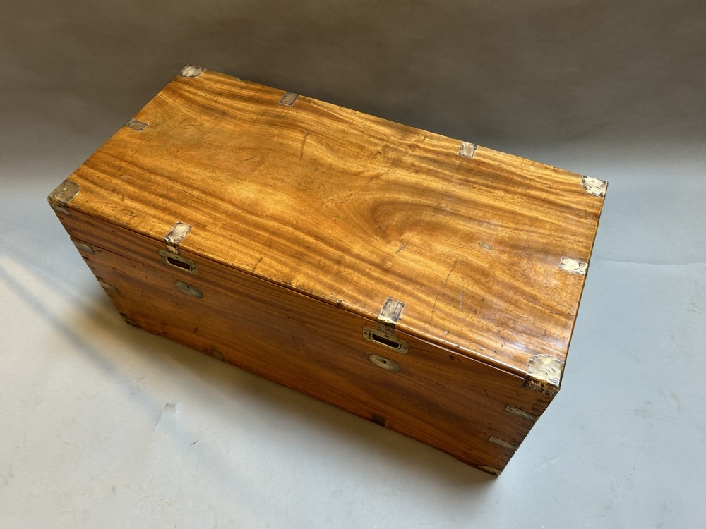 A rectangular 19th-century camphor wood campaign trunk featuring corner brass bindings, flush-fitting handles, and keyhole escutcheons. View II