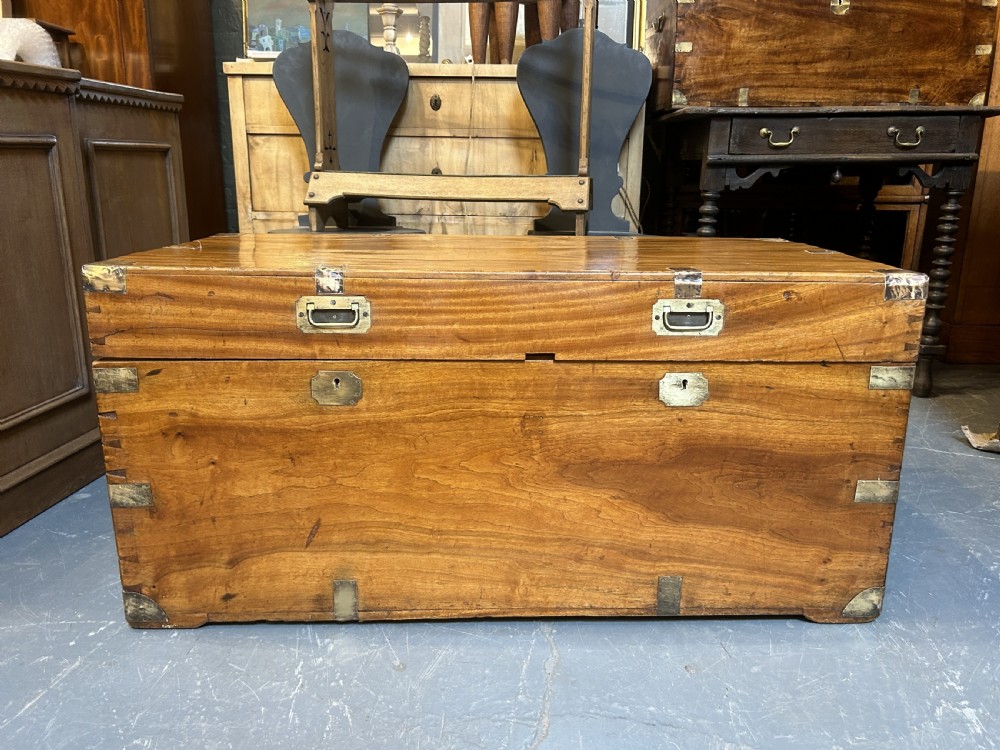 A rectangular 19th-century camphor wood campaign trunk featuring corner brass bindings, flush-fitting handles, and keyhole escutcheons. View III