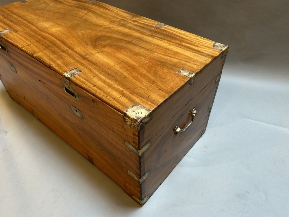 A rectangular 19th-century camphor wood campaign trunk featuring corner brass bindings, flush-fitting handles, and keyhole escutcheons. View IV