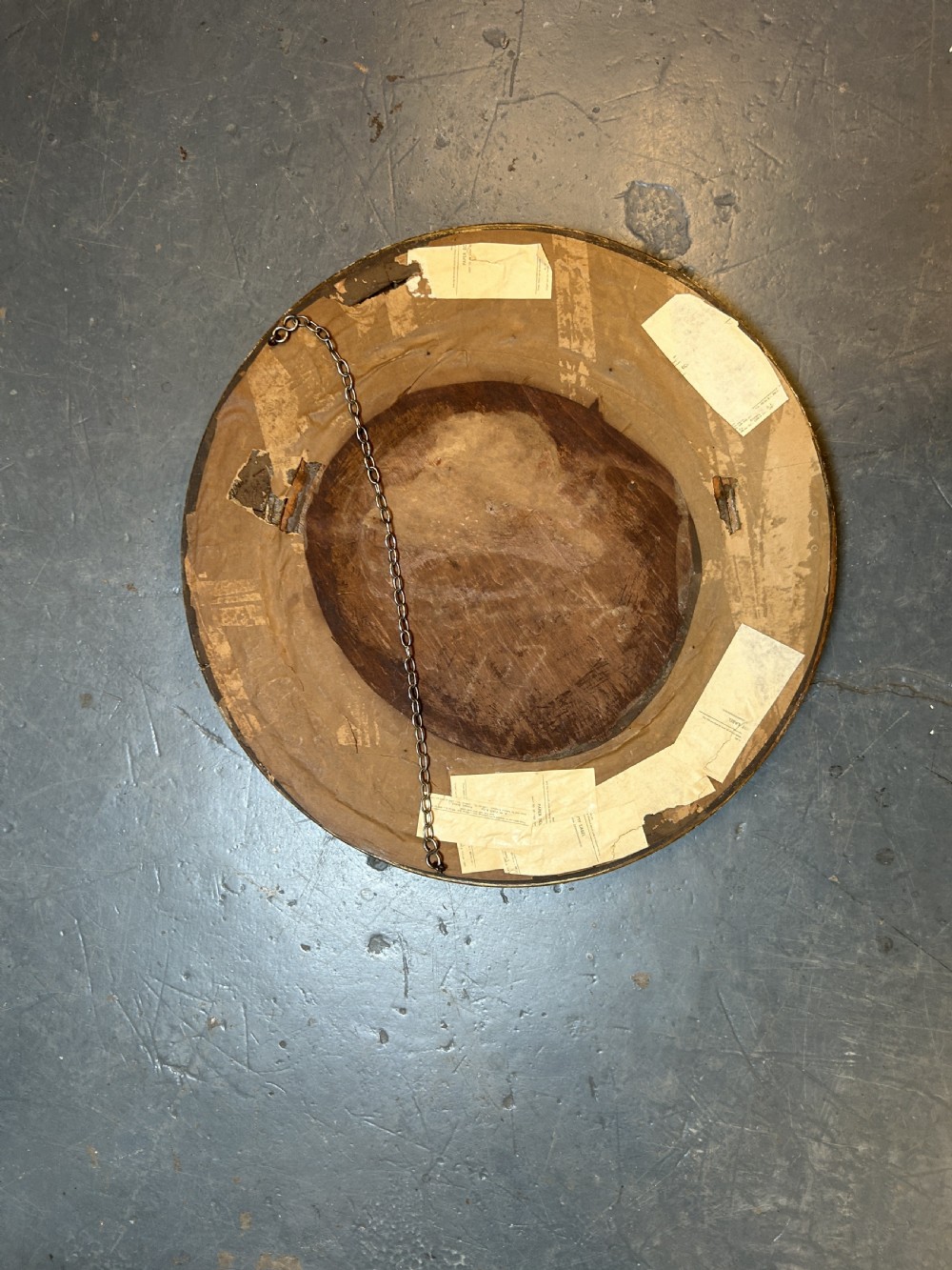 A circular Victorian wall mirror featuring a carved gold gilt frame with moulded gadrooned detail. View VI