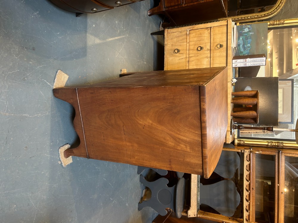 A George III bow front chest of drawers in warm brown timber, featuring three graduated drawers with turned wooden handles and splayed feet. View XI