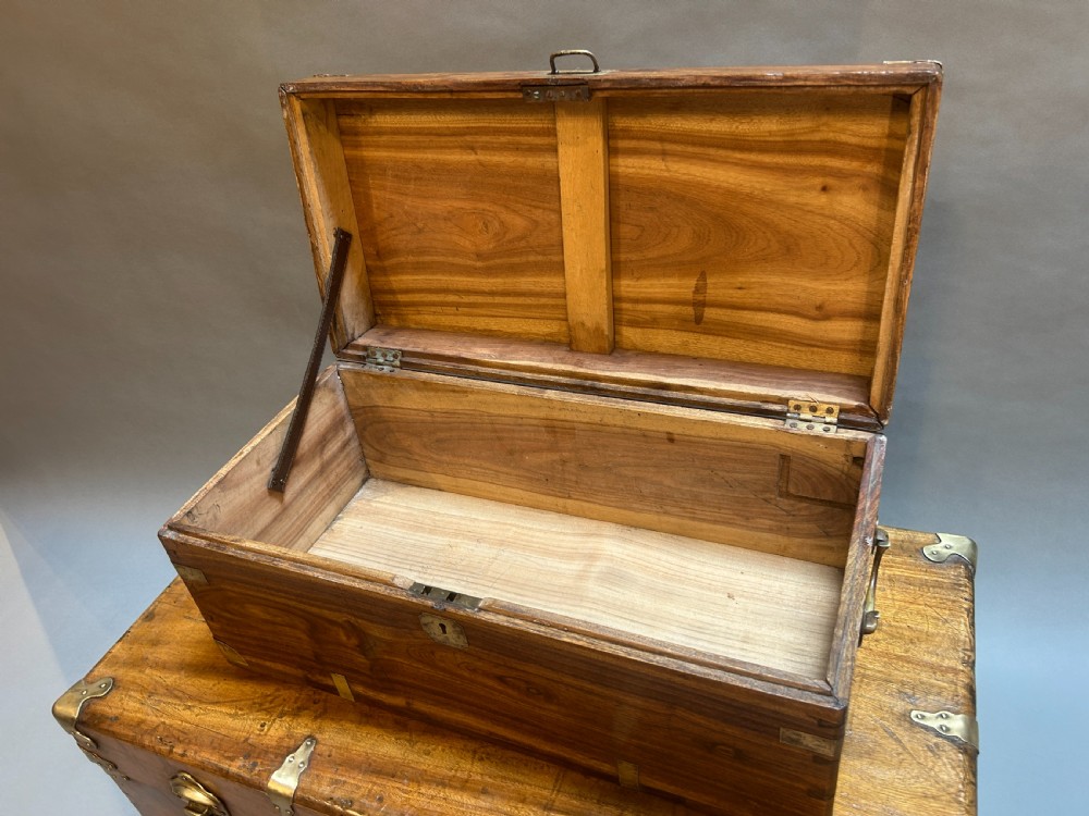 A small nineteenth-century camphor wood campaign trunk with brass corner mounts, flush handles, and keyhole escutcheon. View V