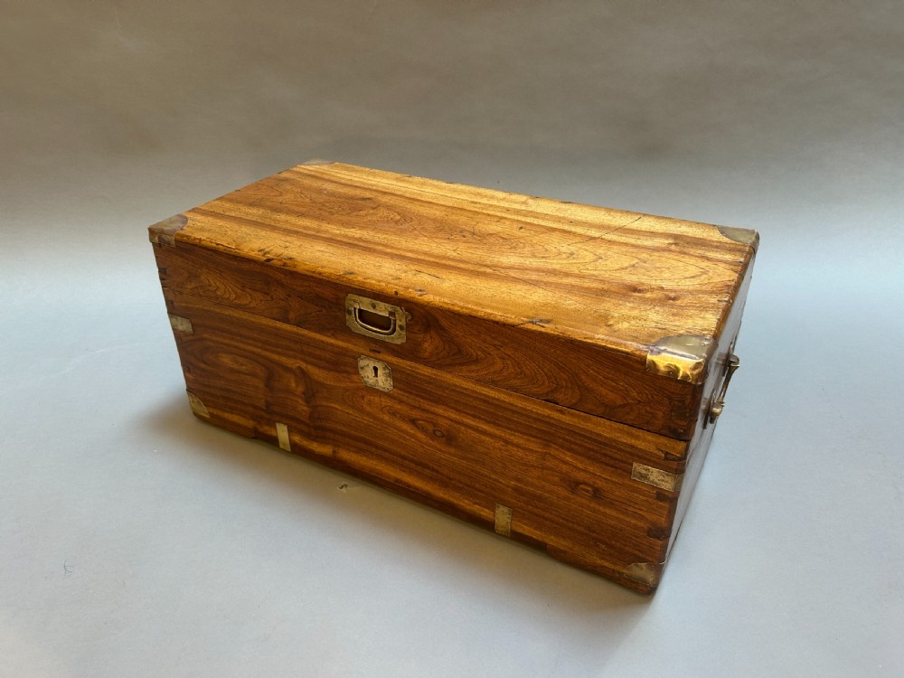 A small nineteenth-century camphor wood campaign trunk with brass corner mounts, flush handles, and keyhole escutcheon. View VI