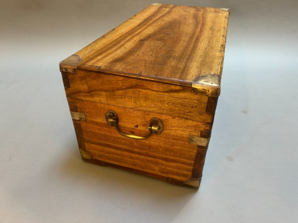A small nineteenth-century camphor wood campaign trunk with brass corner mounts, flush handles, and keyhole escutcheon. View VIII