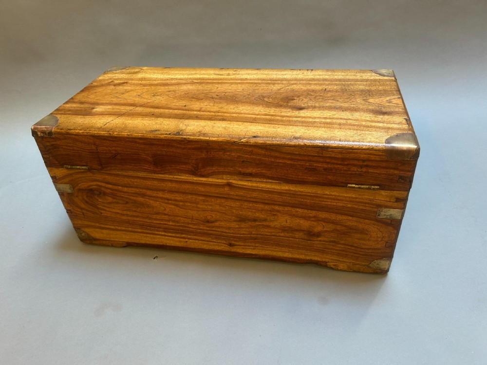 A small nineteenth-century camphor wood campaign trunk with brass corner mounts, flush handles, and keyhole escutcheon. View IX