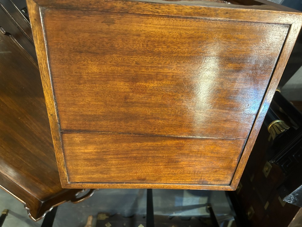 A George III mahogany nightstand featuring a shaped gallery top tier, an open middle shelf, a single drawer with a brass knob, and a shaped cross stretcher at the base. View IX