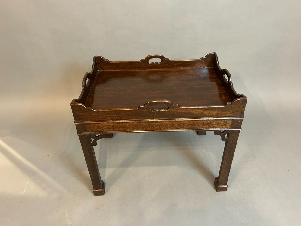 A dark mahogany Georgian style tray top coffee table with integrated side handles, gallery rim, and corner fretwork brackets. View II
