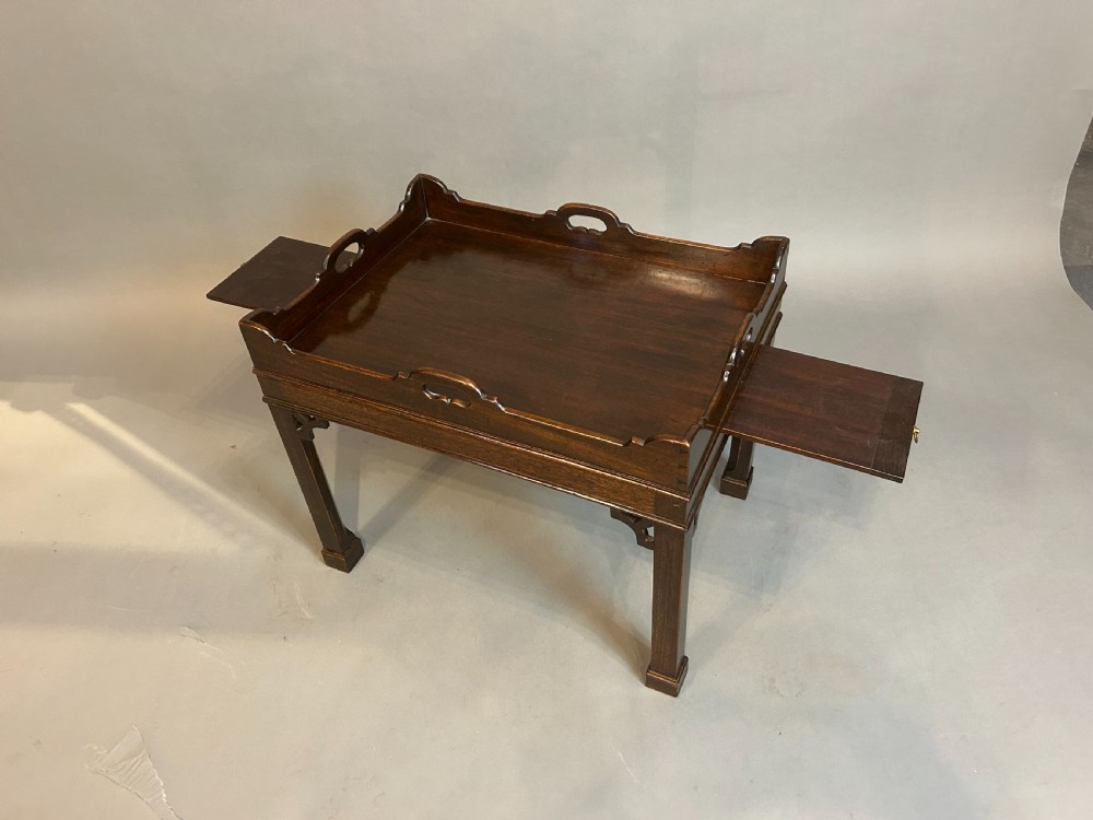 A dark mahogany Georgian style tray top coffee table with integrated side handles, gallery rim, and corner fretwork brackets. View III