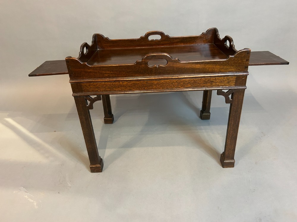 A dark mahogany Georgian style tray top coffee table with integrated side handles, gallery rim, and corner fretwork brackets. View IV