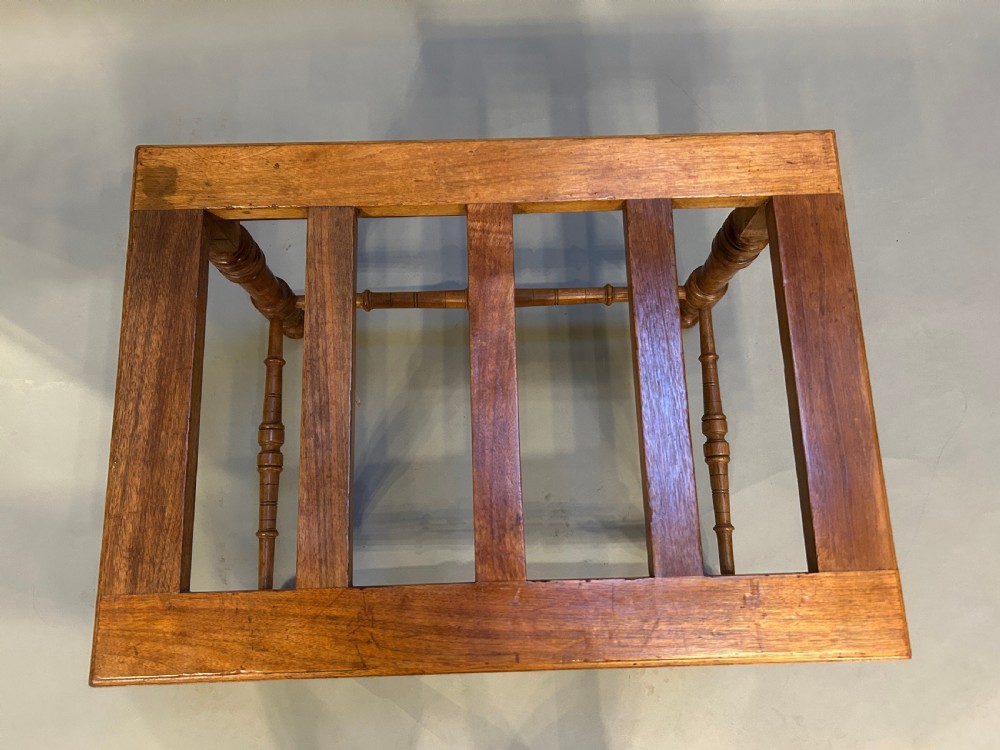 A Victorian wooden luggage stand featuring a slatted top surface supported by four turned legs with horizontal turned stretchers. View VI
