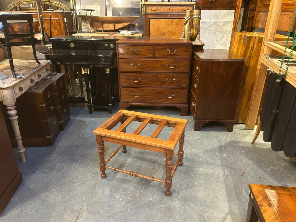 A Victorian wooden luggage stand featuring a slatted top surface supported by four turned legs with horizontal turned stretchers. View VIII