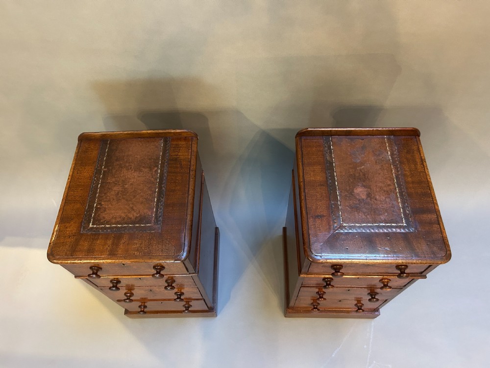 A pair of matching Victorian mahogany narrow bedside chests featuring four drawers with turned wooden knobs and leather inset tops. View III