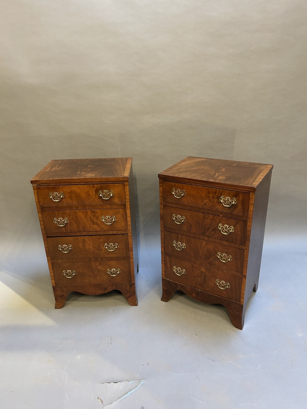 A pair of matching Victorian mahogany narrow bedside chests featuring four drawers with turned wooden knobs and leather inset tops. View XII