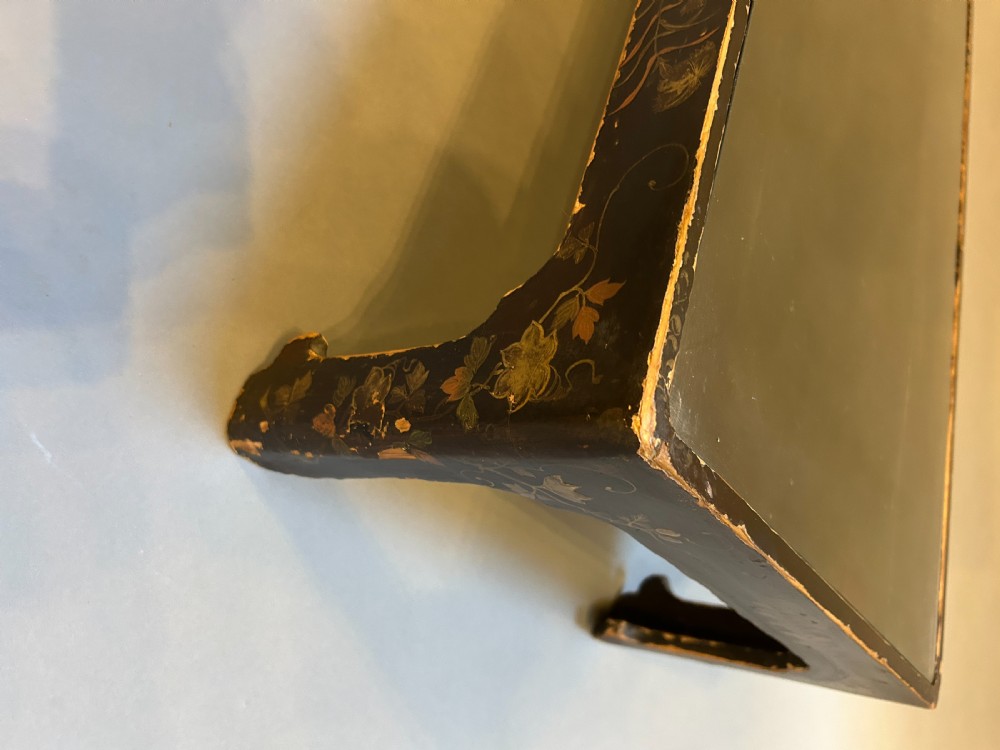 A low rectangular antique Chinese black lacquered coffee table decorated with hand-painted floral motifs and corner apron detail. View II