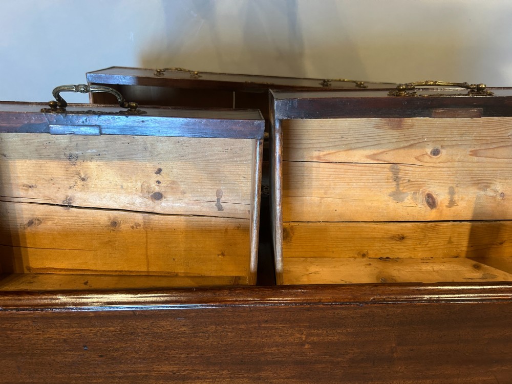 A George III dark mahogany hall chest of drawers featuring brass swan-neck handles, keyhole escutcheons, and bracket feet. View VII