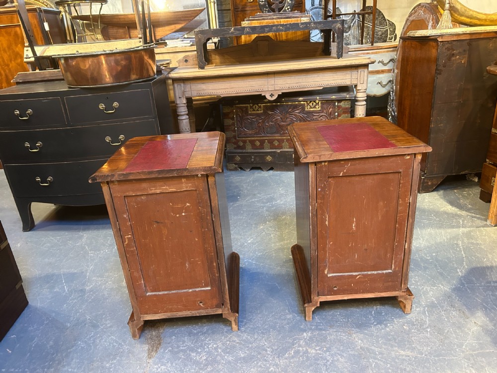 A pair of matching Victorian mahogany bedside chests of drawers featuring inset red leather tops and three drawers with turned wooden knobs. View XI